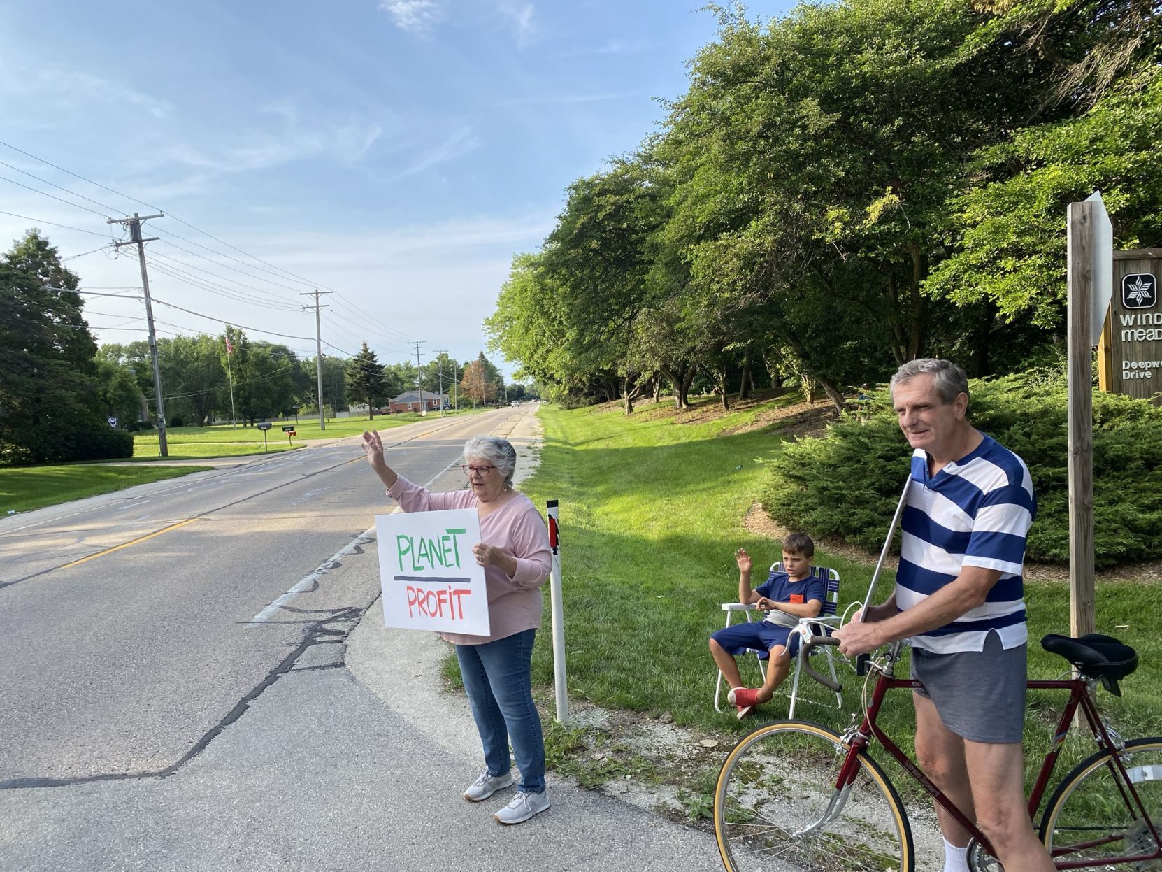 Protestors hold signs